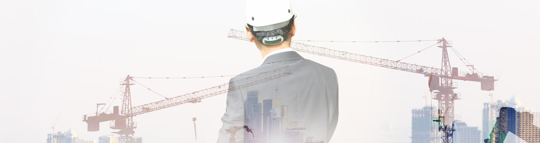 Focused builder wearing hard hat and tool belt at construction site
