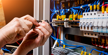 Skilled electrician inspecting wiring with professional expertise